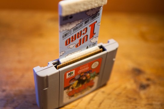 1 up card with N64 cartridge N64-1-up-card